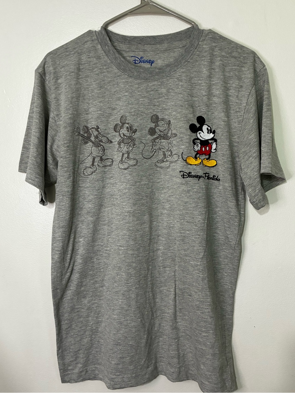 Disney Gray Short-Sleeve Mickey Evolution Graphic Tee with Red & Yellow Accents